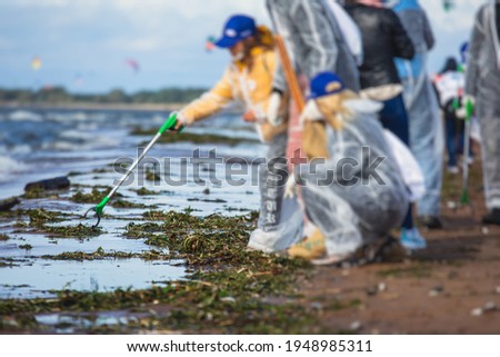 Process of cleaning up the shore beach line from litter garbage rubbish trash, group of eco volunteers remove oil products leak spill, plastic waste and dump removing, ecological problems concept