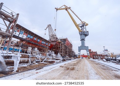 The process of completing the construction of a large icebreaker. The ship has been launched and is being outfitted.