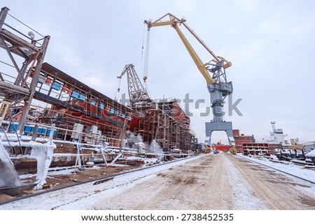 The process of completing the construction of a large icebreaker. The ship has been launched and is being outfitted.