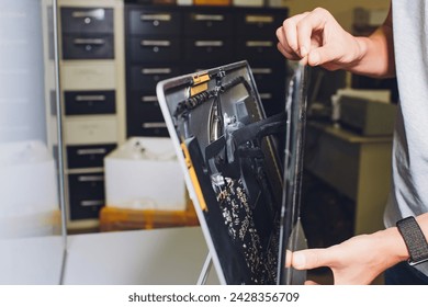 Process of computer repair. Engineer in white gloves disassembling computer