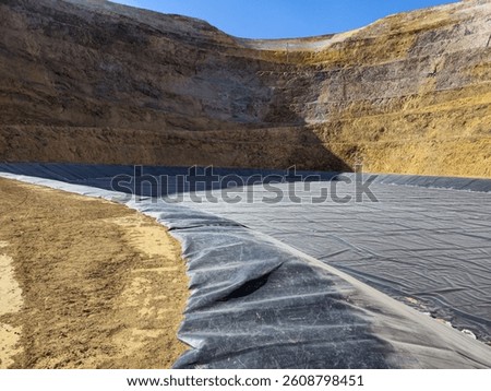 Process of constructing water pools with geosynthetic materials at the bottom of an open-pit mine.