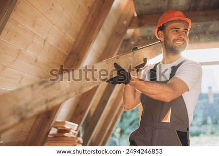 Process of construction new and modern modular house. Worker man in special protective uniform wear working on building development industry of energy efficient property.