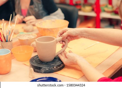 The process of creating a ceramic cup on a potter's wheel in art studio