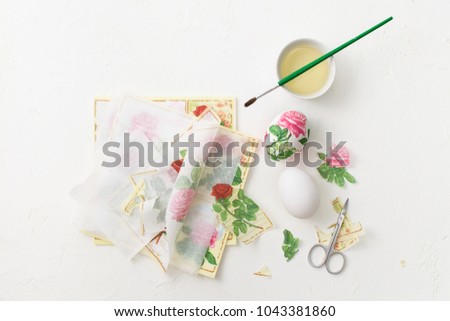 The process of creating decoupage on eggs in floral style. A delicate pink palette. Copy space text.