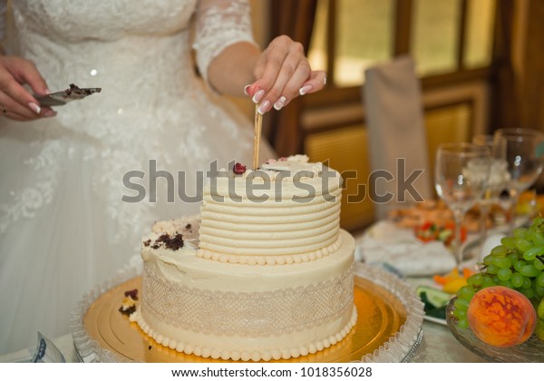 The\
process of cutting the cake the newlyweds\
apart.