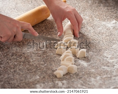 the process of cutting the dough into smaller pieces for cooking