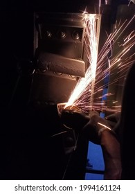 the process of cutting iron using a grinder that causes sparksb