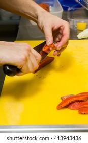the process of cutting salmon on a cutting board 