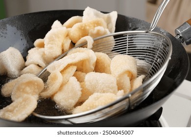 Process Deep Frying Crackers in the Hot Oil, Kitchen Step by Step. Goreng Kerupuk, Indonesian Crackers