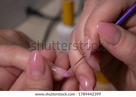the process of doing manicure. Closeup of hands of professional manicurist, applying nail polish. Concept of doing manicure and fingernails cleaning. beauty concept. Gel polish, shellac
