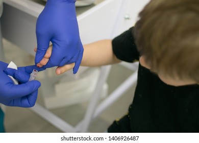 The Process Of Drawing Blood From A Finger For Analysis In A Boy