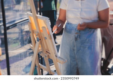 Process of drawing, group class of talented students with painting easels and canvases during lesson of watercolour painting outdoors, drawing class for adult artists in art school  - Powered by Shutterstock