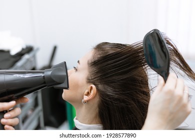 The Process Of Drying Hair With A Hair Dryer In A Beauty Salon After Care Procedures