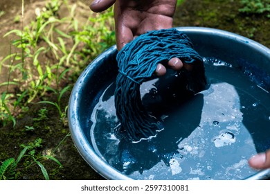 The process of dyeing the yarn with indigo paste. Indigo is a natural source of blue color from the plant Strobilanthes cusia. Indigo dyeing is a natural oxidation process.