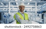 Process Engineer Smiling, Looking at Camera. Portrait of a Caucasian Man in a Protective White Hardhat and Reflective Jacket. Specialist Monitoring AI Powered Assembly Line With Heavy Machinery.