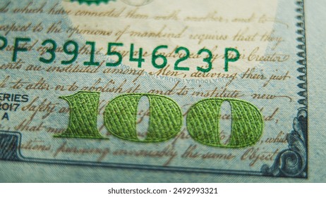 Process of examining authenticity of hundred dollar bill for currency exchange or payment. 100 US dollar banknote with Benjamin Franklin. Paper money. Finance and banking concept. Extreme Close Up.