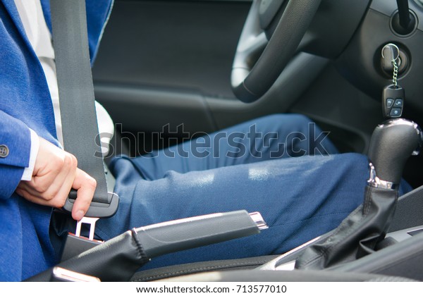 the process of fastening the safety belt by the\
driver before the trip