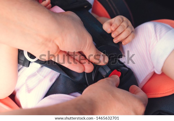 The process of\
fastening seat belts on a child restraint seat in the car. Safety\
for children, transport\
safety