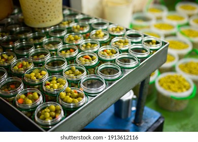 Process Of Filling Of Glass Jars With Pickled Olives In Packaging Shop At Artisanal Food Producing Factory