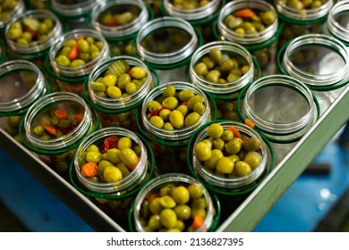 Process Of Filling Of Glass Jars With Pickled Olives In Packaging Shop At Artisanal Food Producing Factory