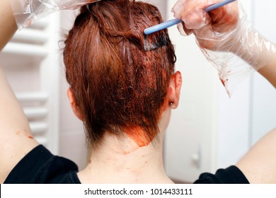 Process Of Hair Coloring At Home. Applying Red Color To The Hair. 