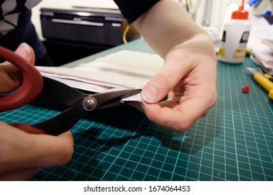 the process of handmade creating of the diary from special scrapbooking paper, paper flowers and other decorative elements