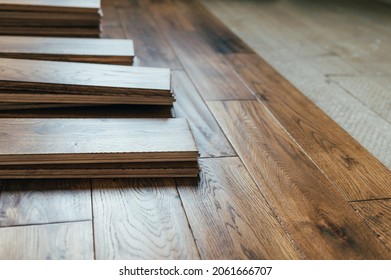The process of house renovation with changing of the floor from carpets to solid oak wood. Beautiful golden handscraped oiled European oak brushed for added texture and fine definition of wood grain - Shutterstock ID 2061666707