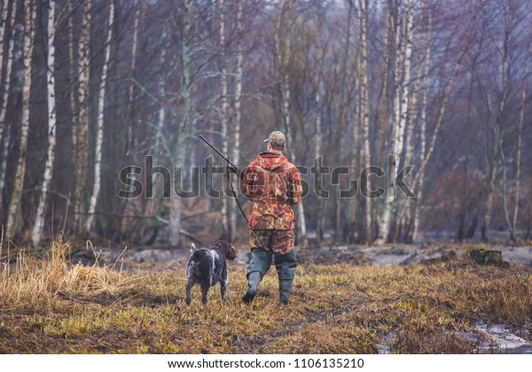 A process of hunting during hunting season, process\
of duck hunting, group of hunters and drathaar, german wirehaired\
pointer dog\
