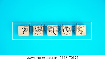 The process of idea formation or creation and problem solving. Thinking, analyzing, research, information gathering and idea icons on wooden cubes. on a blue background.                     