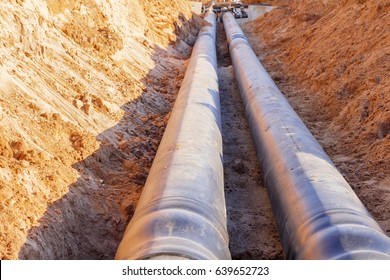 The process of installation of the distribution unit heating network. Frame for connecting pipes in the trench of sand.