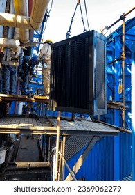 The process of installing the air preheater element in a coal fired steam power plant by several workers