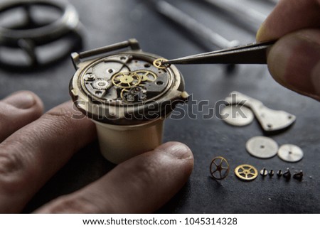 The process of installing a part on a mechanical watch, watch repair