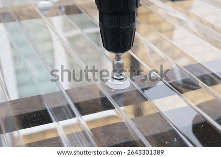 Process of installing a roofing material for a canopy made of transparent polycarbonate, tightening the fasteners, a thermal washer and a self-tapping screw close-up