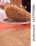 The process of isolating paddy from chaffs.
