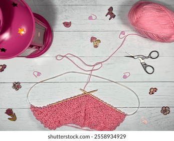 Process of knitting yarn thread and needles and scissors and flashlight with a candle decorative photo cozy atmosphere handmade craft art decor design 