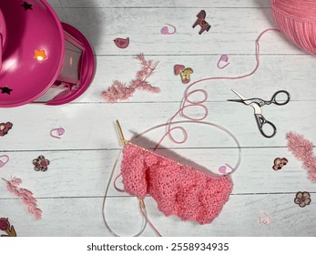Process of knitting yarn thread and needles and scissors and flashlight with a candle decorative photo cozy atmosphere handmade craft art decor design 