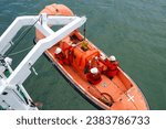 process of launching a rescue boat into the sea, releasing a life boat to perform abandon ship safety drills and man recovery for man overboard drills on board. Davit crane is lowering the life boat