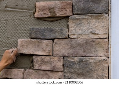 The Process Of Laying Decorative Bricks Stone On The Wall.