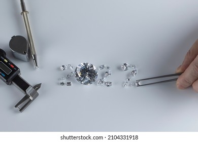 Process Of Laying Out Number 2022 From Diamonds Of Different Sizes And Shapes Using Diamond Dealer Tools. Diamond Expert Workspace With New 2022 Year Top View.