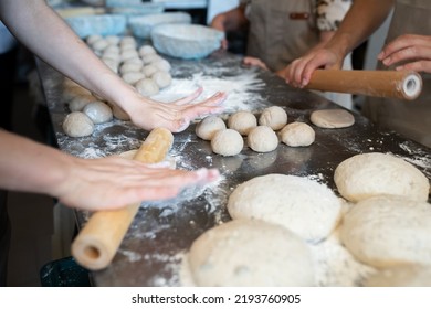 The process of learning how to produce artisan bread in a small bakery. Front view. - Powered by Shutterstock