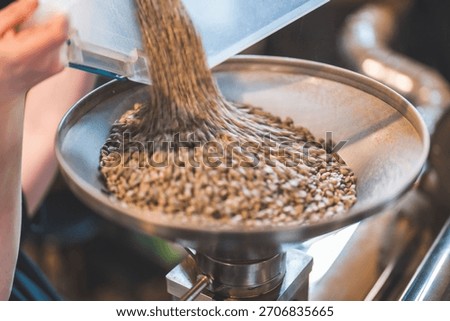 The process of loading up the coffee roaster, closeup shot