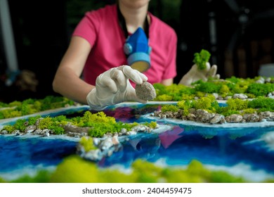 The process of making the art decor of epoxy resin, natural stones and moss