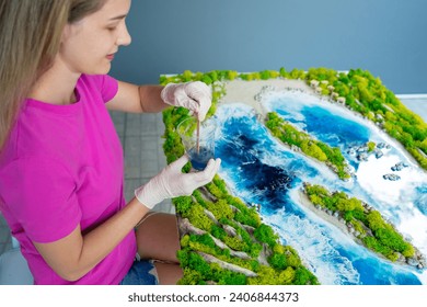 The process of making the art decor of epoxy resin, natural stones and moss
