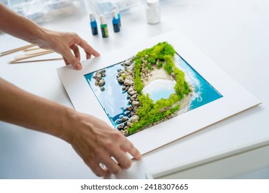 The process of making the art decor of epoxy resin, natural stones and moss