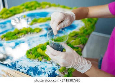 The process of making the art decor of epoxy resin, natural stones and moss