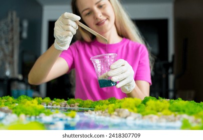 The process of making the art decor of epoxy resin, natural stones and moss