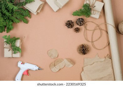 Process of making Christmas tree decorations from craftpaper and wrapping presents. Preparation for holidays. Concept budget savings, zero waste Winter decor holiday.  
