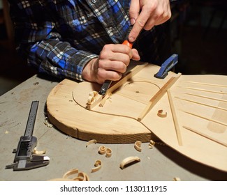 The process of making a classical guitar. Making the right shape of a brace guitar.