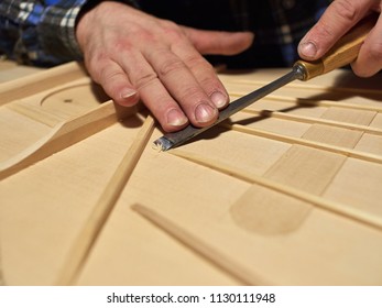 The process of making a classical guitar. Making the right shape of a brace guitar.