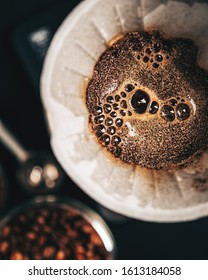 The process of making coffee by the alternative method of purover, paper filter, top view,dark background